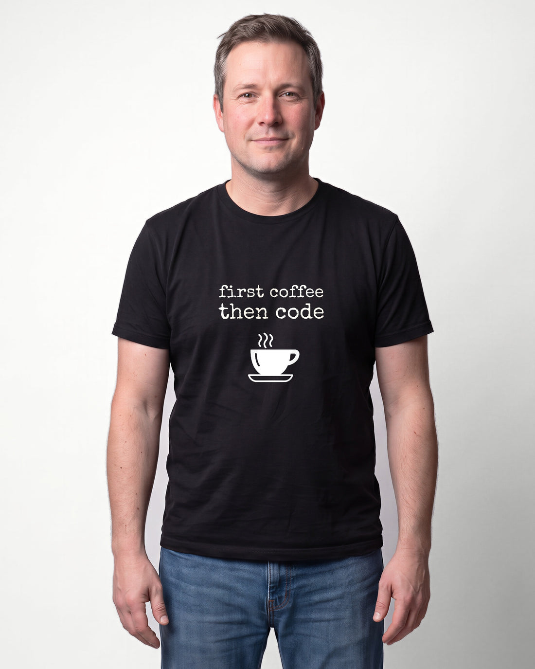 First Coffee Then Code in Black on Bella+Canvas 3001, worn by Marcus. AI-generated model.