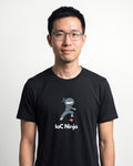 IaC Ninja in Black on Bella+Canvas 3001, worn by Kenji. AI-generated model.