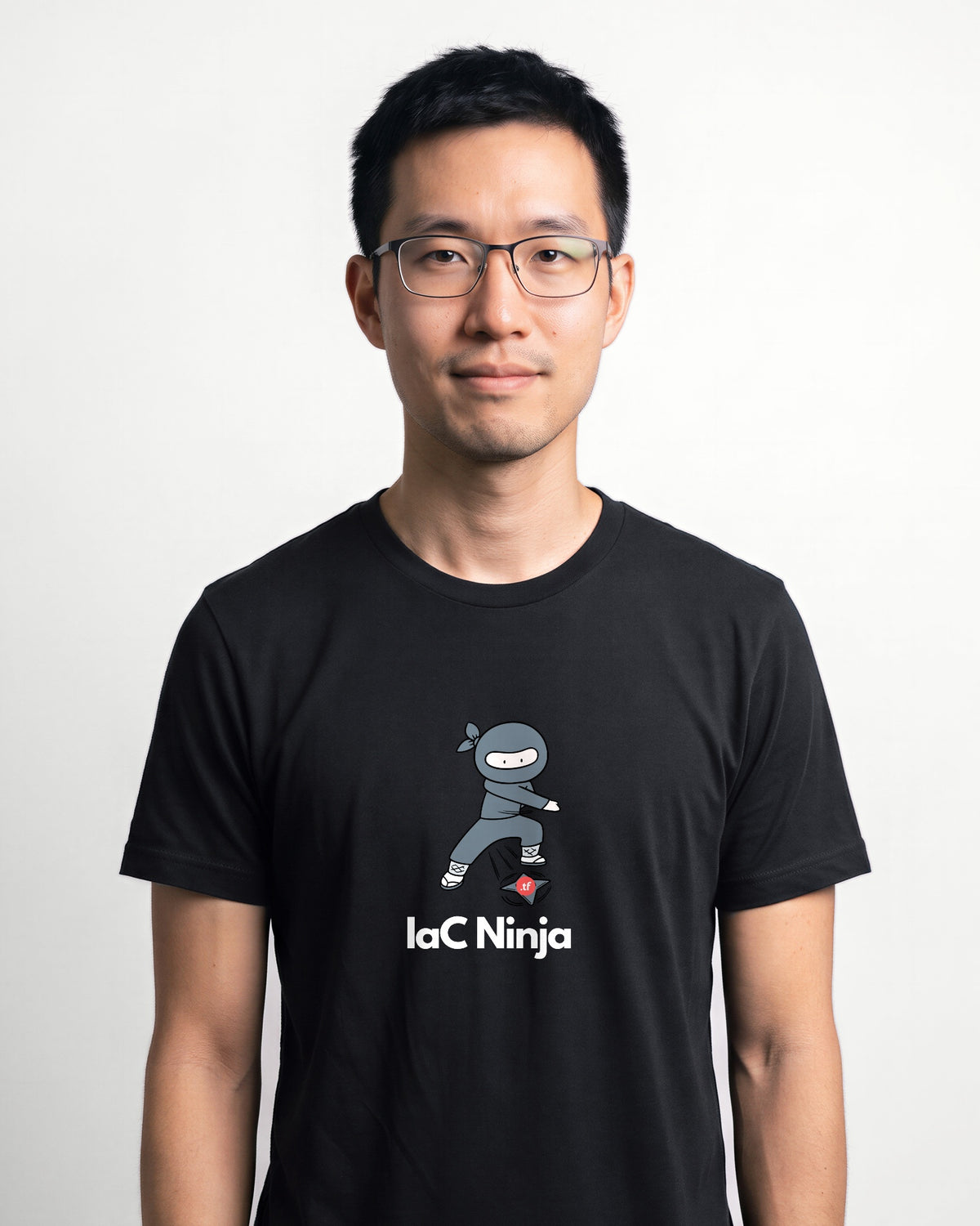 IaC Ninja in Black on Bella+Canvas 3001, worn by Kenji. AI-generated model.