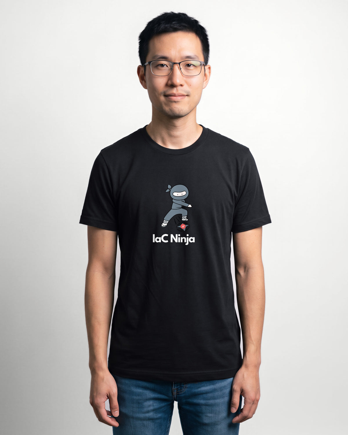 IaC Ninja in Black on Bella+Canvas 3001, worn by Kenji. AI-generated model.