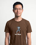 IaC Ninja in Brown on Bella+Canvas 3001, worn by Kenji. AI-generated model.