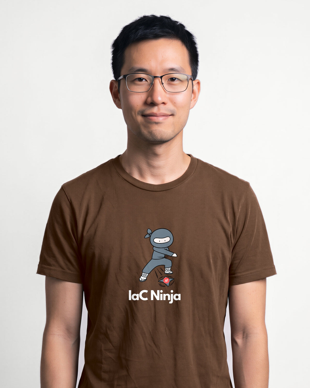 IaC Ninja in Brown on Bella+Canvas 3001, worn by Kenji. AI-generated model.