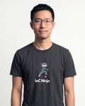 IaC Ninja in Dark Grey Heather on Bella+Canvas 3001, worn by Kenji. AI-generated model.