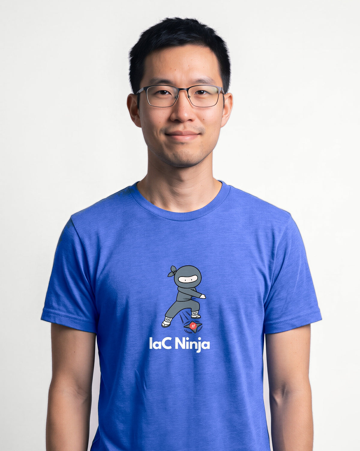 IaC Ninja in Heather True Royal on Bella+Canvas 3001, worn by Kenji. AI-generated model.