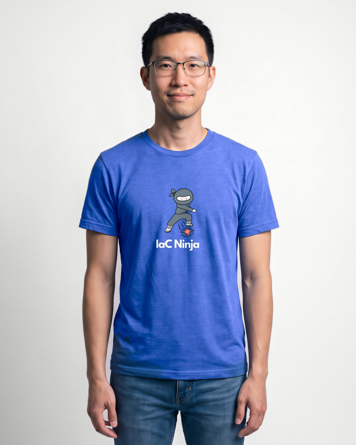 IaC Ninja in Heather True Royal on Bella+Canvas 3001, worn by Kenji. AI-generated model.