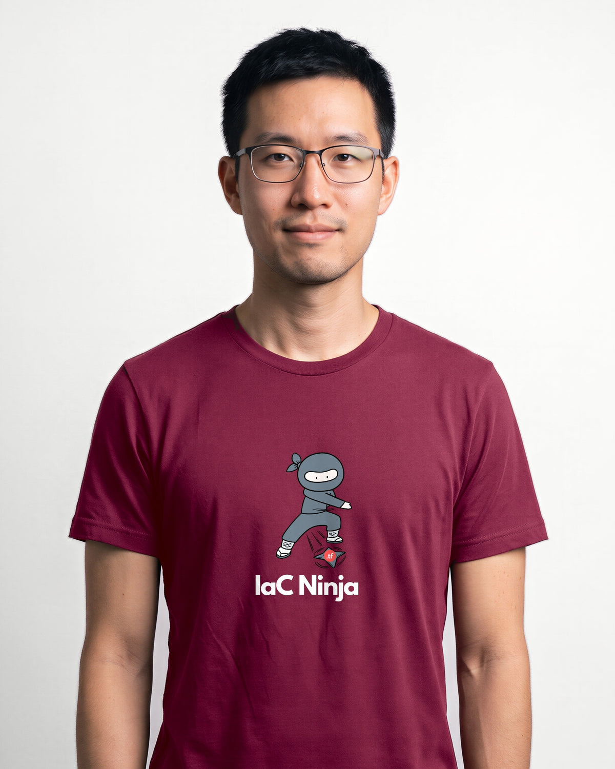 IaC Ninja in Maroon on Bella+Canvas 3001, worn by Kenji. AI-generated model.