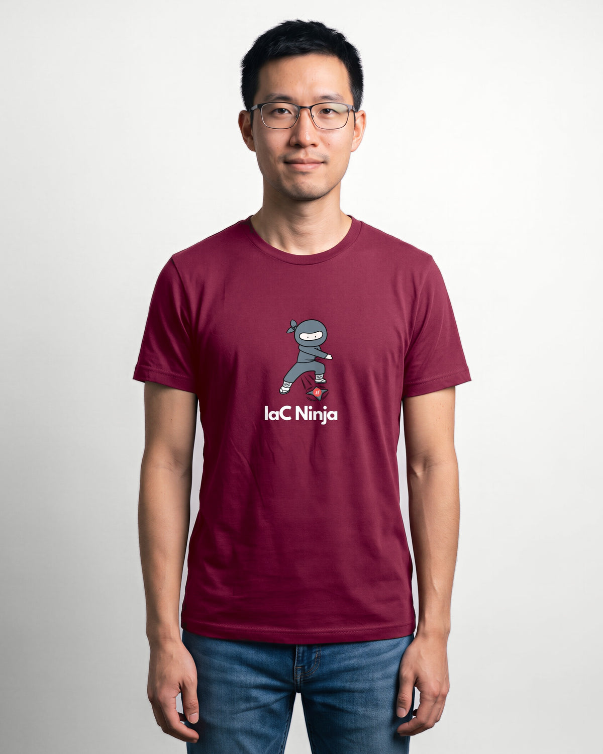 IaC Ninja in Maroon on Bella+Canvas 3001, worn by Kenji. AI-generated model.