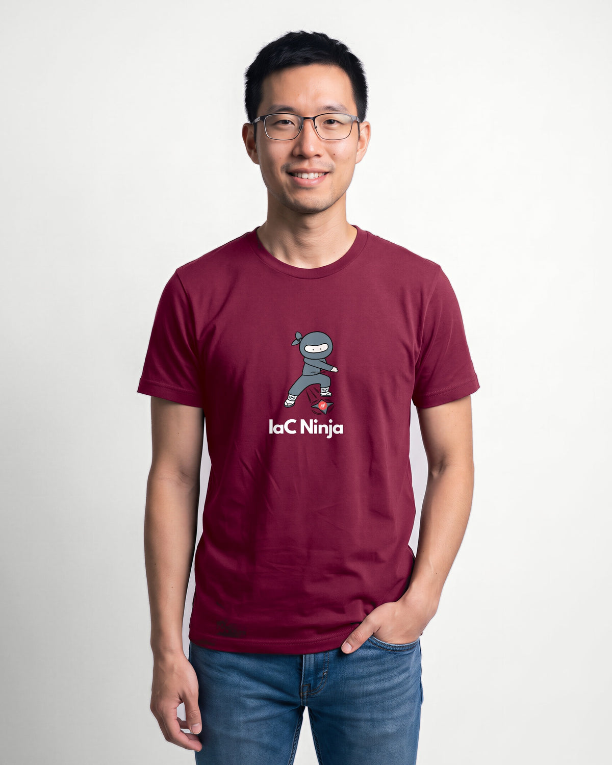 IaC Ninja in Maroon on Bella+Canvas 3001, worn by Kenji. AI-generated model.